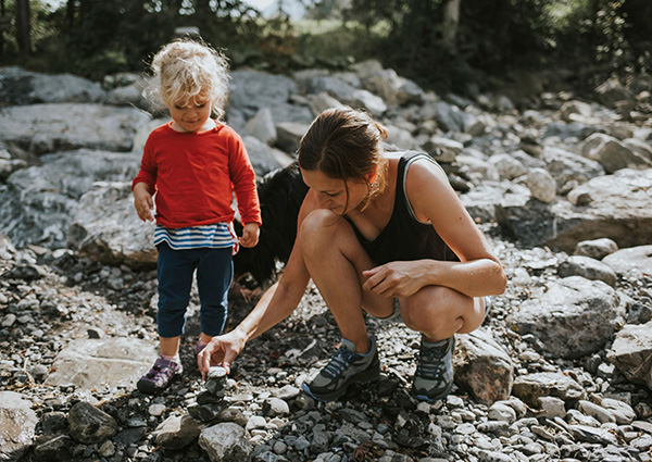 mom and daughter looking at rocks